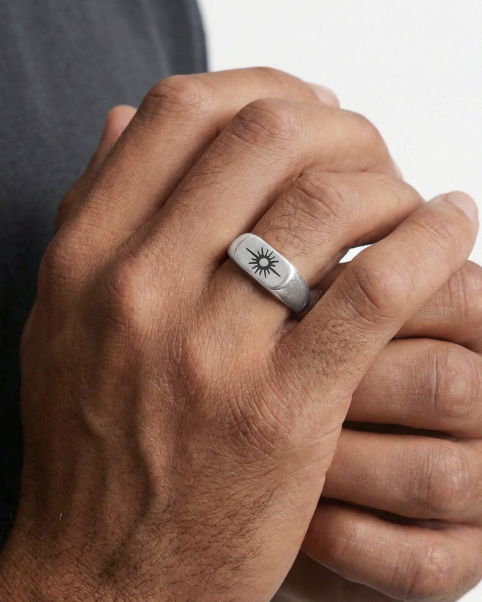 Horizon Silver Ring worn on finger with sun motif engraving