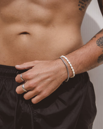 Belize Caribbean freshwater pearl necklace draped around a man's neck