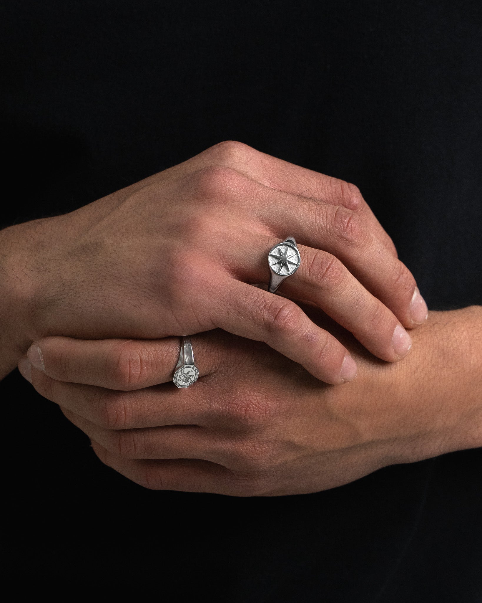 Legacy Silver Ring with a starburst face worn on the finger
