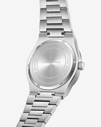 Close-up of the stainless steel case back with bracelet links on a silver AUREN watch.