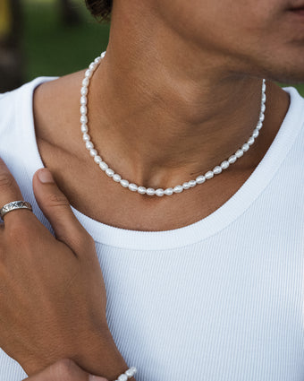 Belize Pearl Chain necklace with white pearls draped around the wearer's neck.