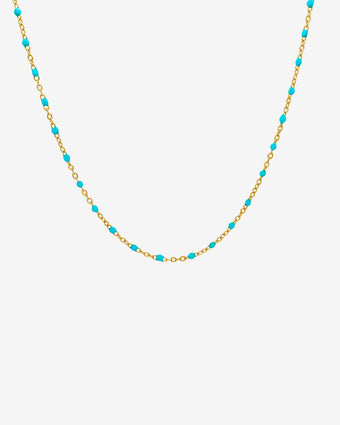 Gold chain necklace with turquoise beads displayed on a white background