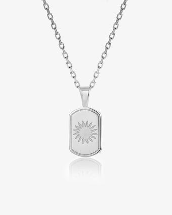 DAYSTAR silver necklace with a rectangular sunburst pendant on a white backdrop