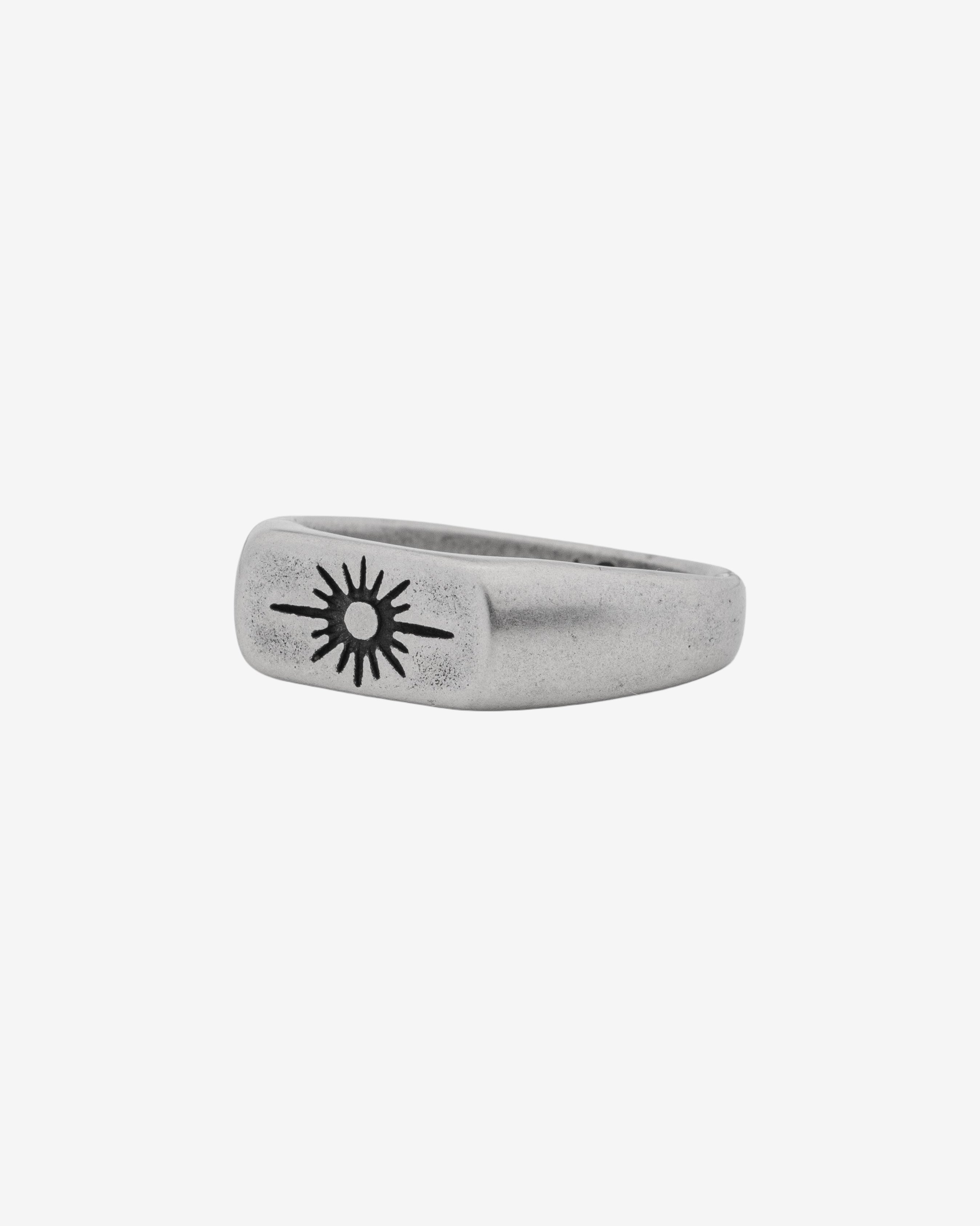 Horizon Silver Ring with sunburst emblem on finger in a brushed silver finish