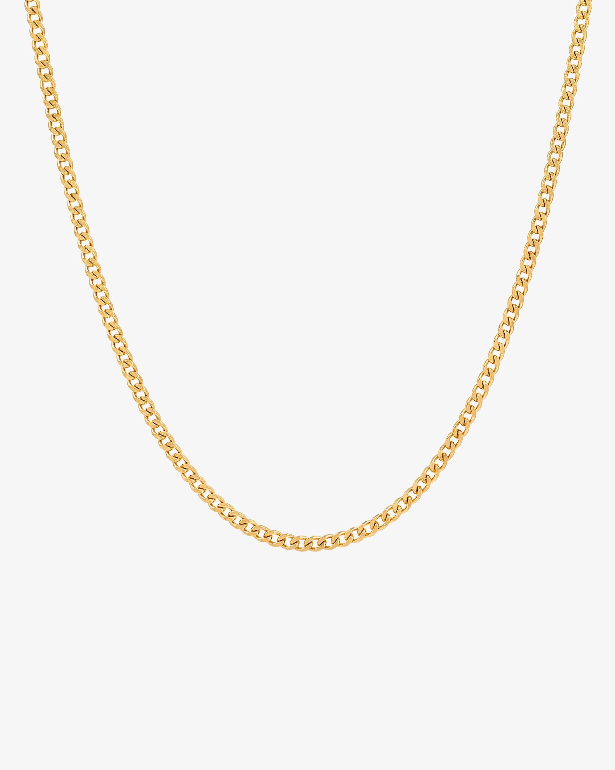 Close up of a minimalist 3 mm gold Cuban link chain