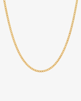 Close up of a minimalist 3 mm gold Cuban link chain