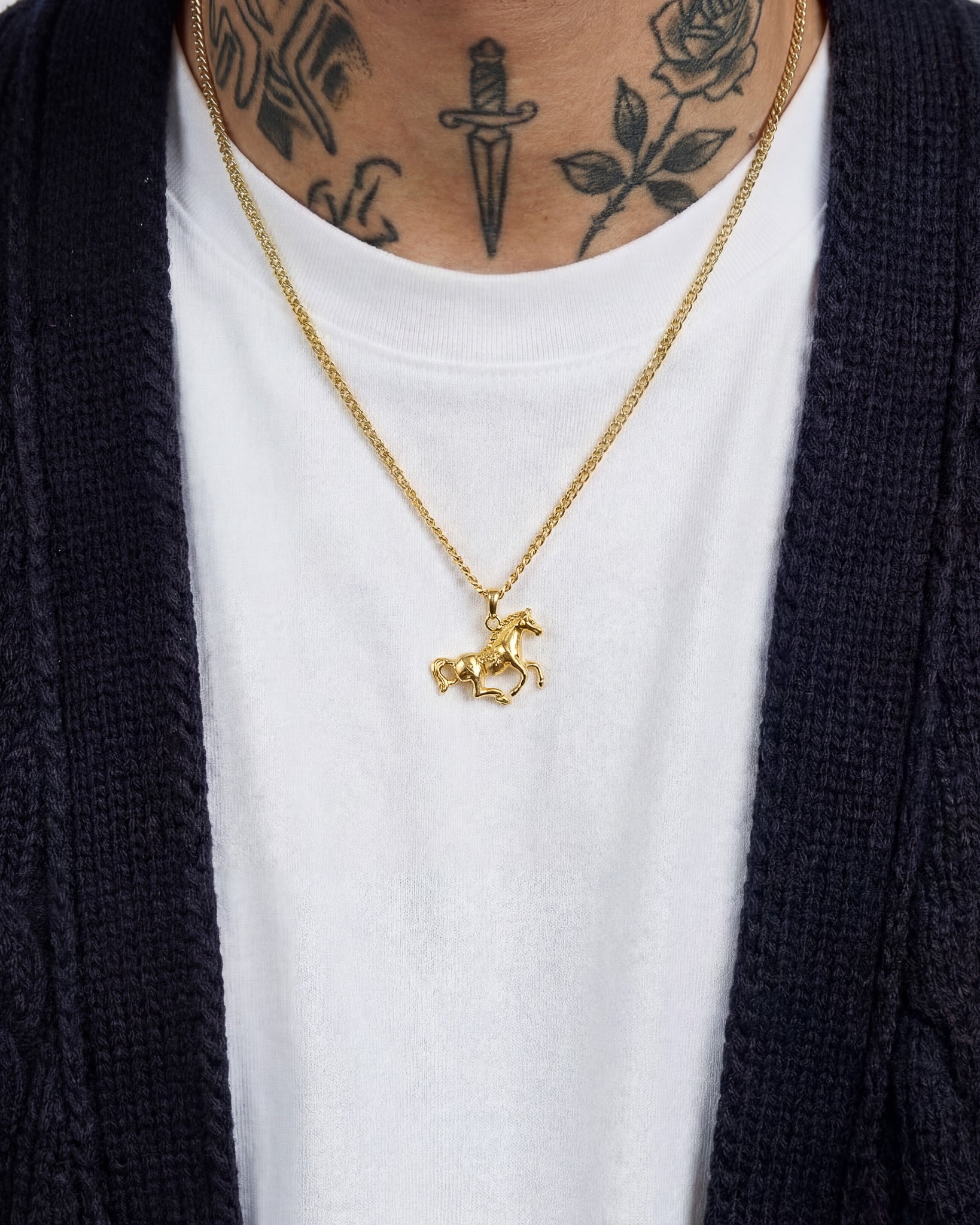 Monaco Gold Necklace worn by a model over a white tee, horse pendant visible at chest.