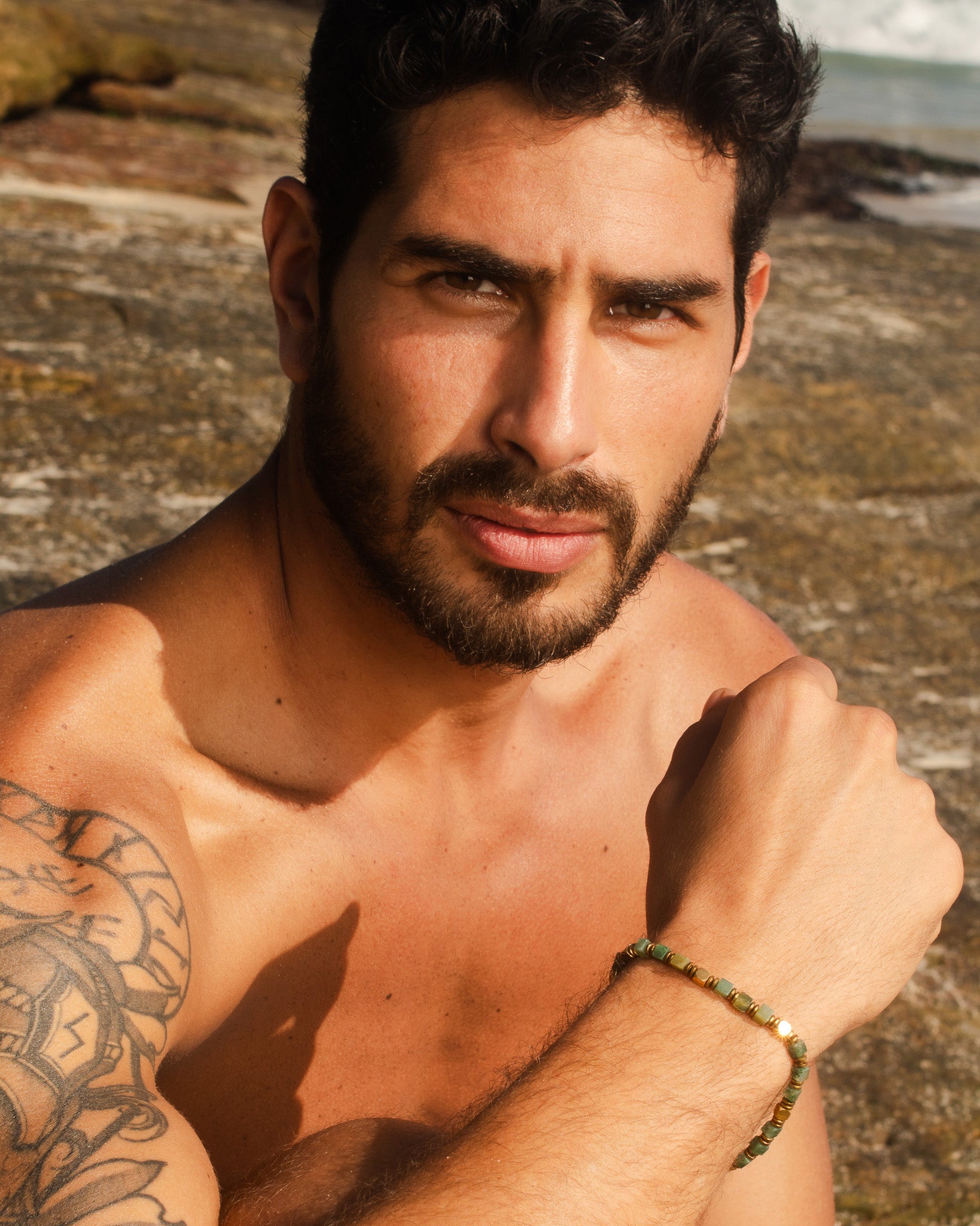 Moss agate and hematite bead bracelet on a man's wrist