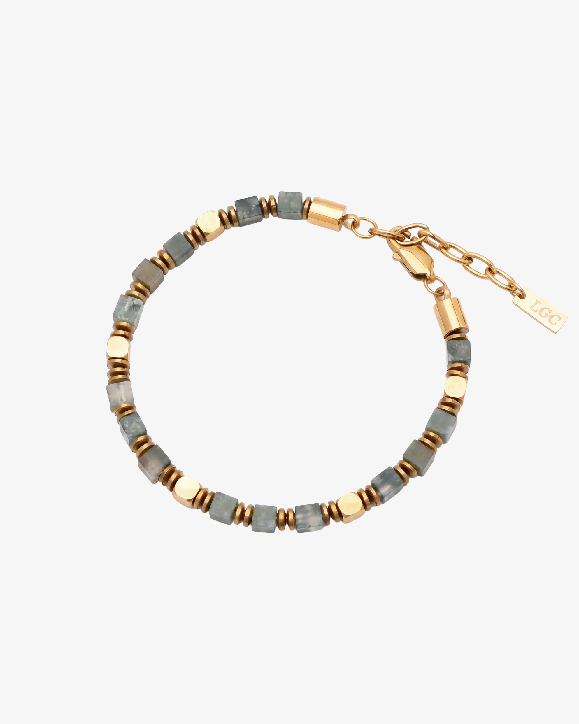 Close up of moss agate and hematite bracelet with gold spacers resting on a wrist