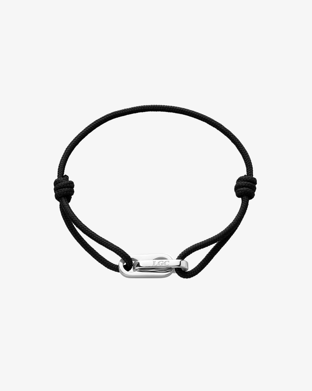 Partial view of a black braided cord bracelet with a silver clasp on a light background