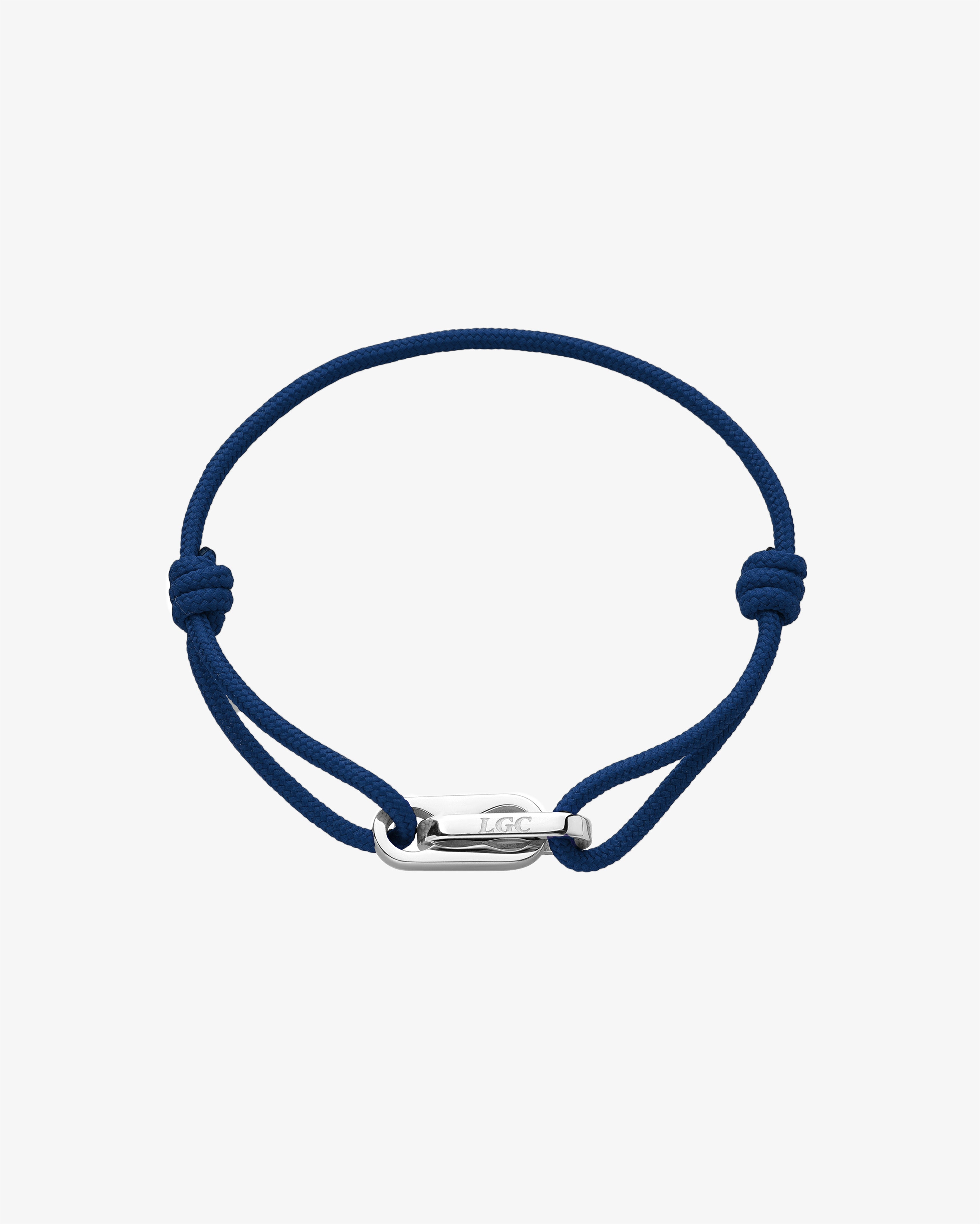 Atlantis silver bracelet on blue cord with adjustable clasp worn on the wrist