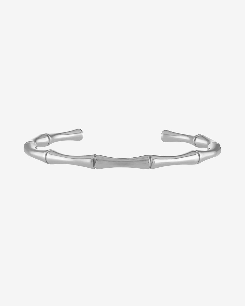 Bamboo inspired silver bracelet around a wrist against a pale background