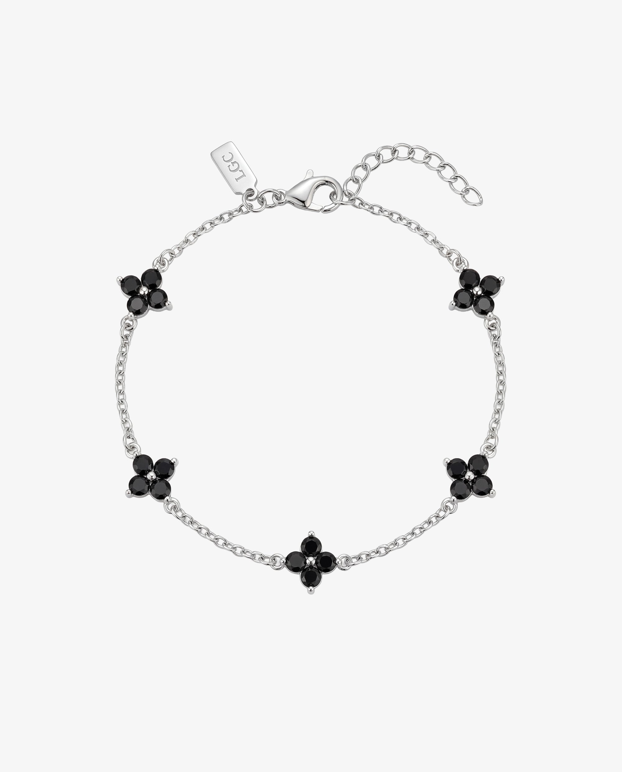 Silver Clover bracelet with black gemstone flower charms along a delicate chain