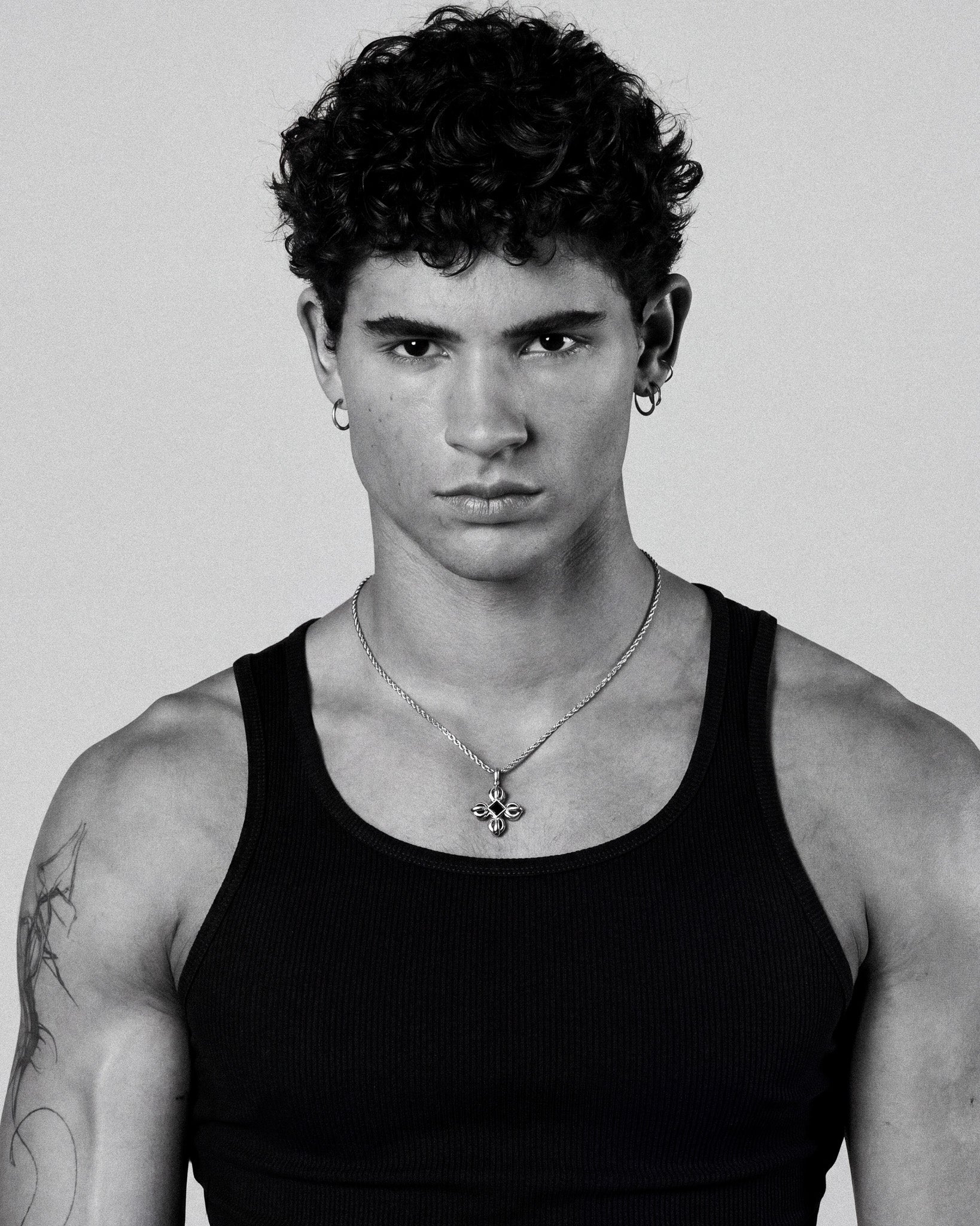 Male model wearing flare silver necklace with pendant resting at the collarbone, 50 cm chain plus 5 cm extender