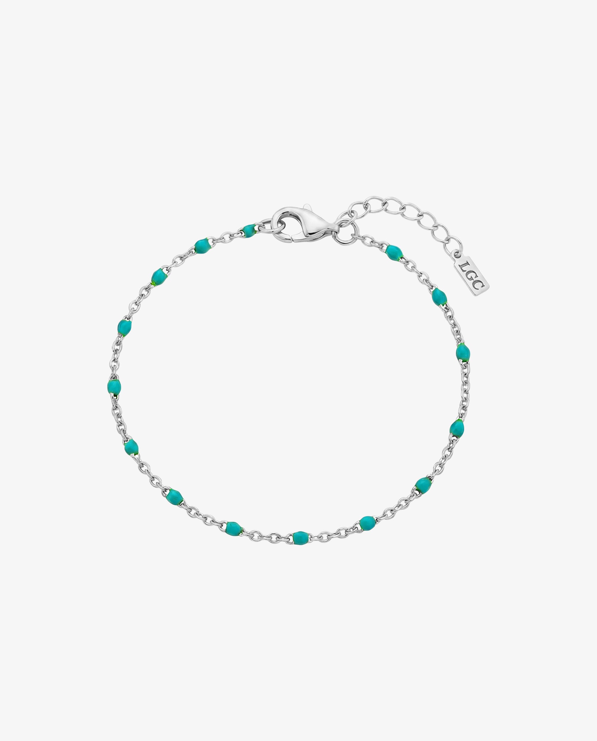 Silver bracelet with turquoise beads and a lobster clasp on a wrist