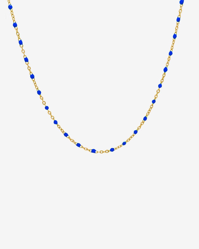GEM GOLD CHAIN necklace with blue beads along a gold chain on a white background