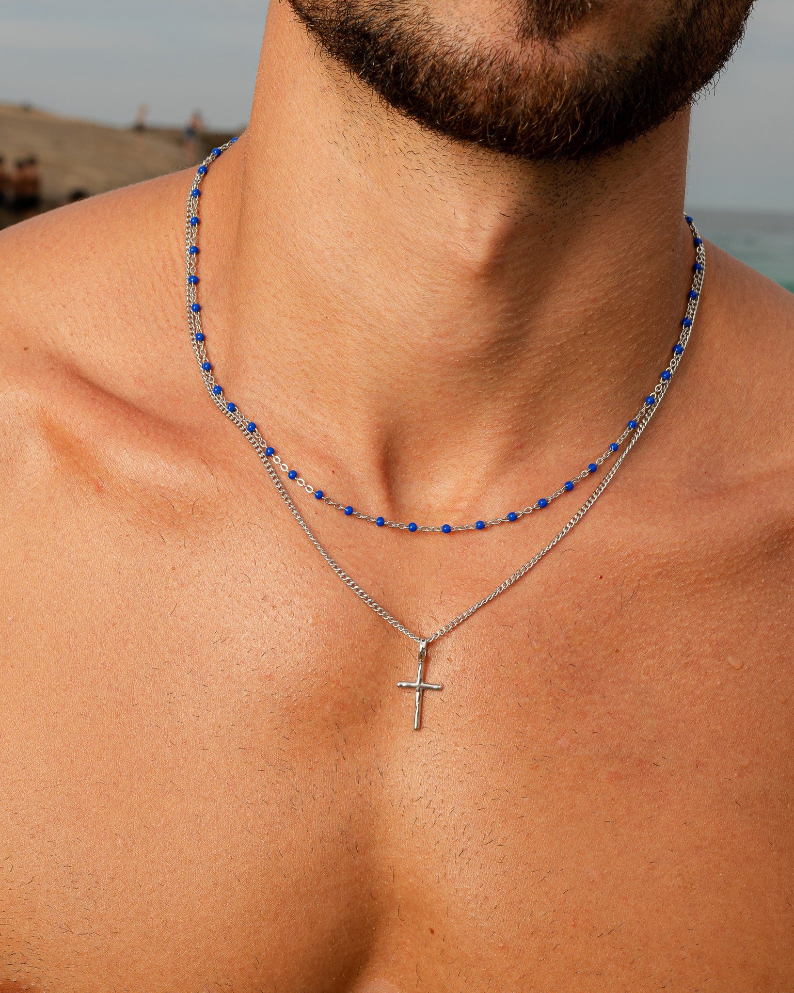 GEM silver chain necklace with blue beads and a dangling cross pendant