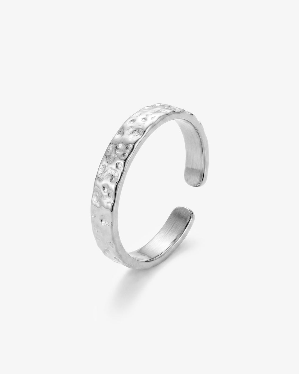 Hammered silver ring with a textured organic surface on a white background.