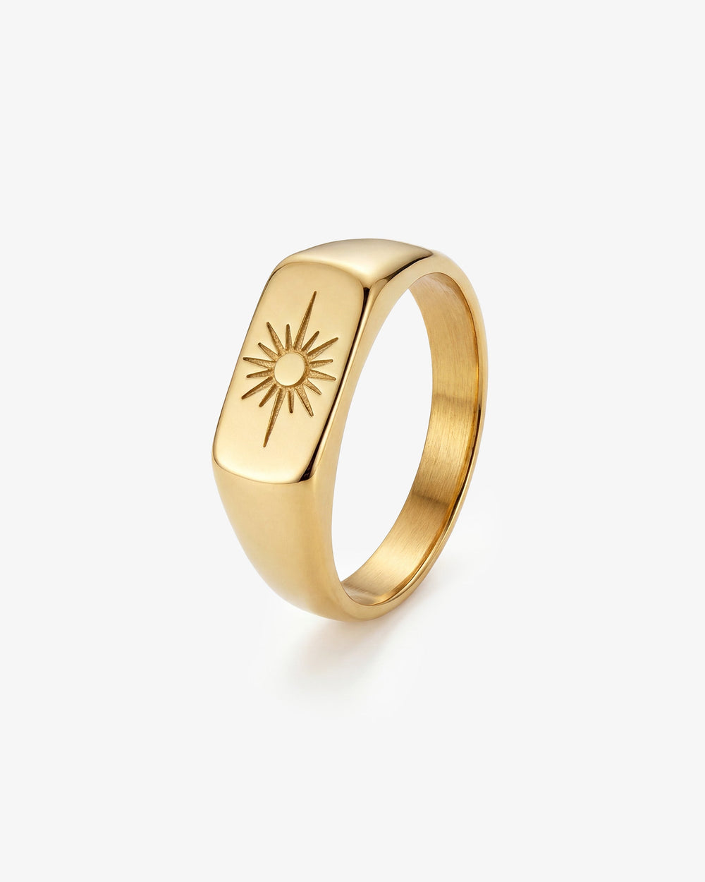 Gold horizon ring on a finger with a sunburst design on the ring face