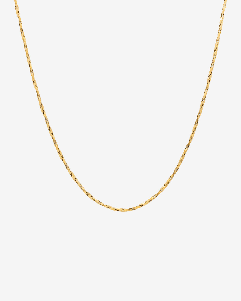 Minimal gold chain with a clean flat-link profile against a light background