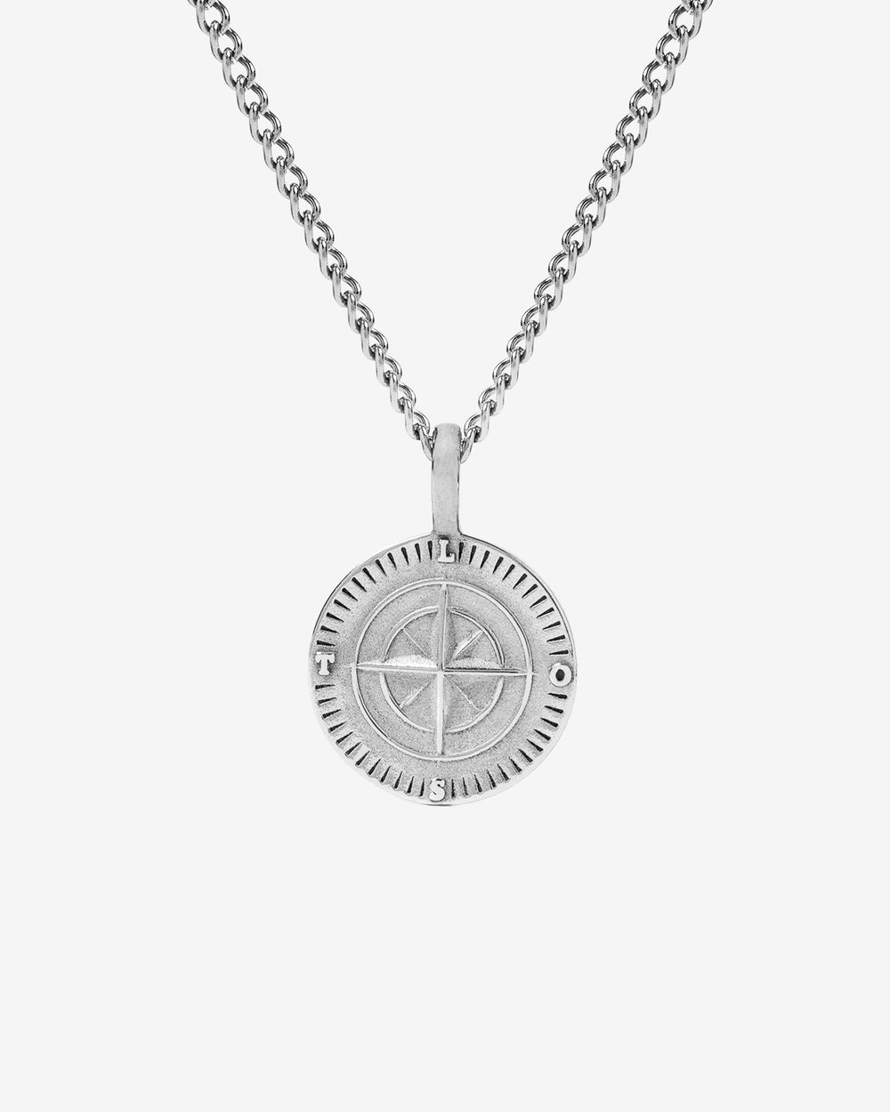 Silver Northwalk necklace with a compass pendant on a chain against a light backdrop