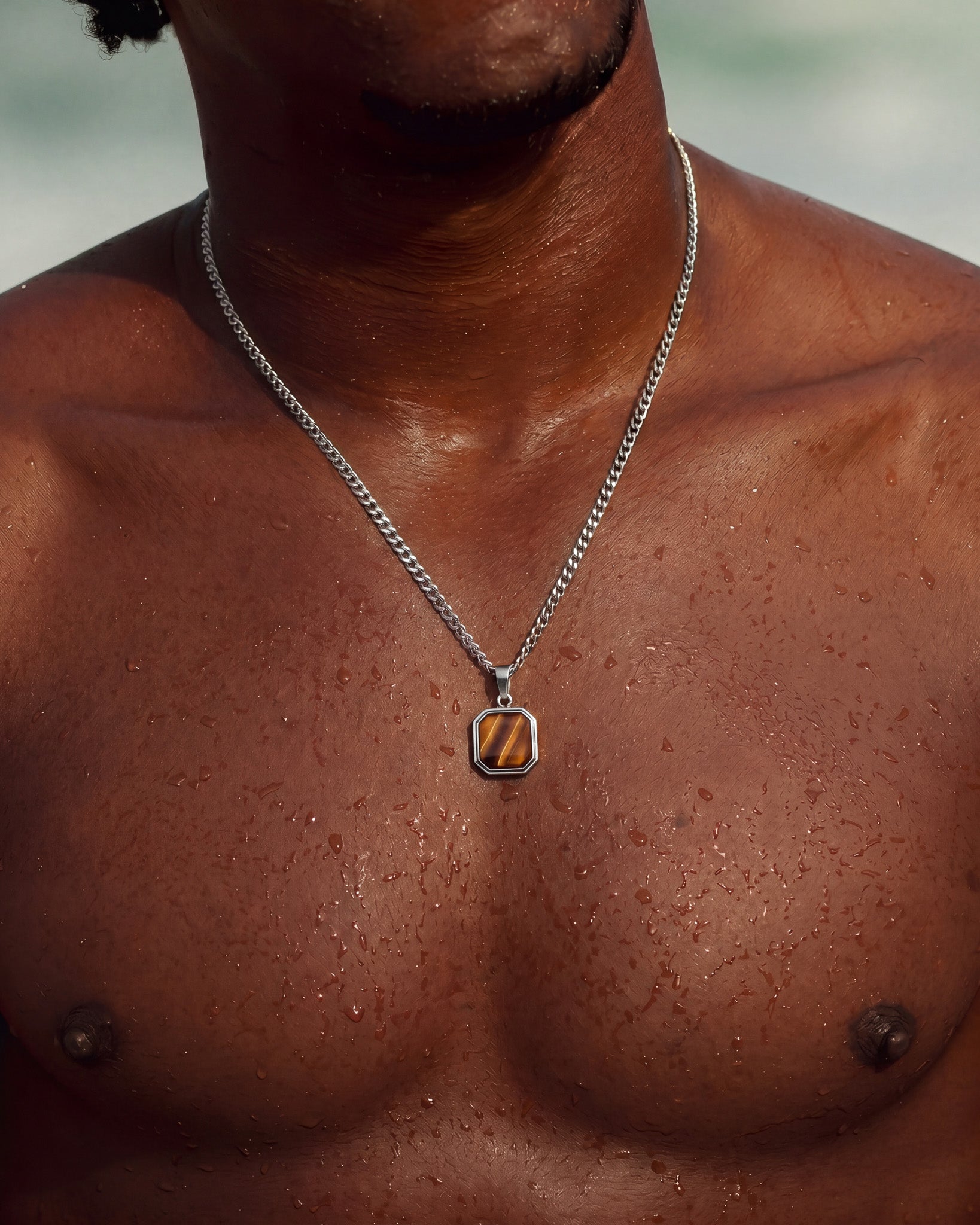 NOVA Silver Necklace with turquoise octagonal pendant worn on a dark chest
