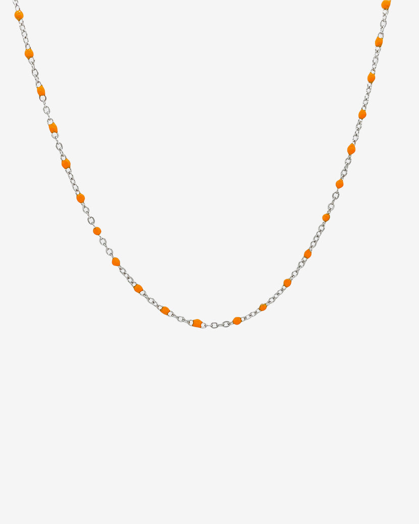 Silver chain necklace with evenly spaced orange beads against a white background
