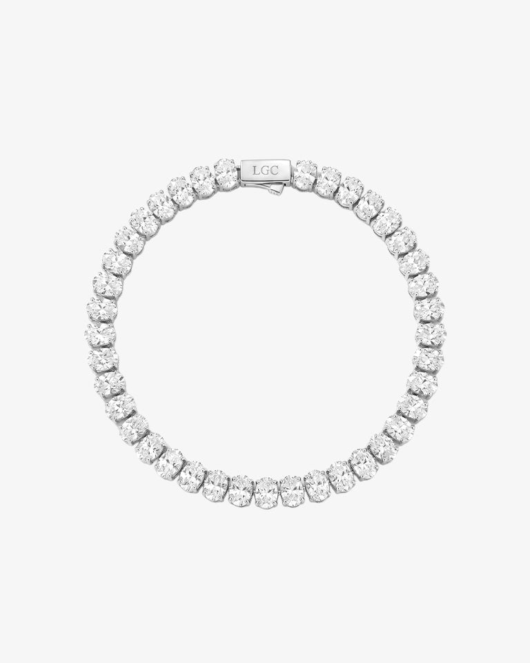 Oval diamond tennis bracelet with a continuous row of stones and a clasp