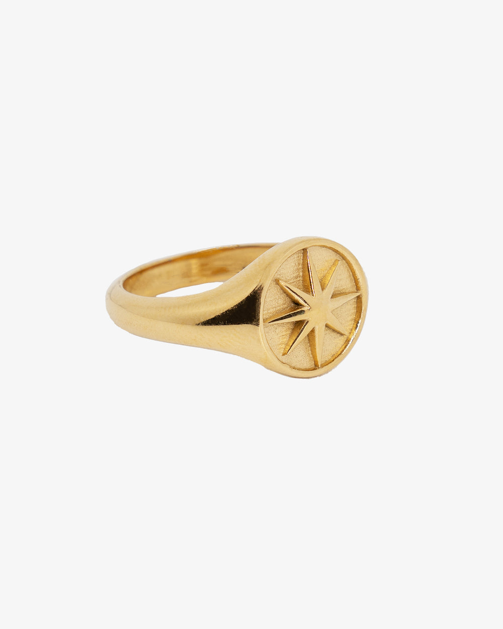 Gold star ring worn on finger in a close-up hand shot