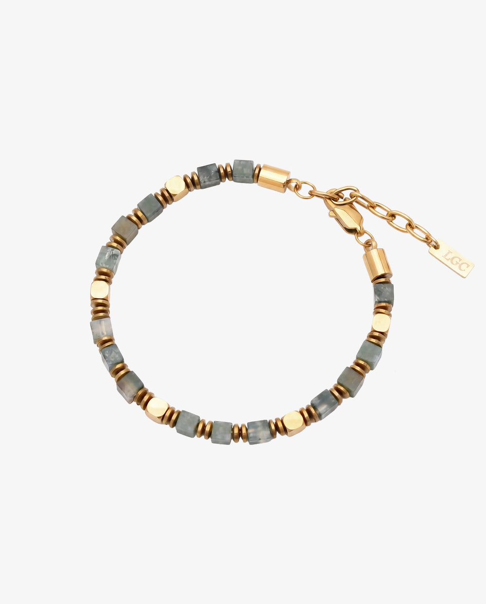 Close up of moss agate and hematite bracelet with gold spacers resting on a wrist