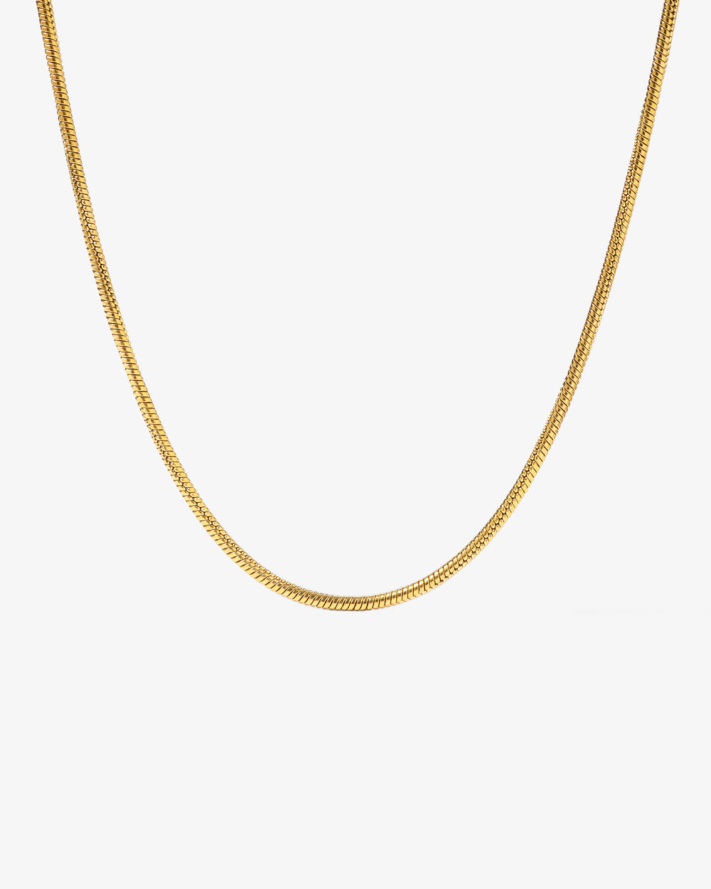 Sunset gold chain with 2 mm wide links laid across a light stone background
