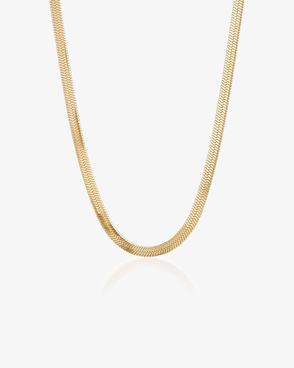 Gold wavy chain necklace on a white background.